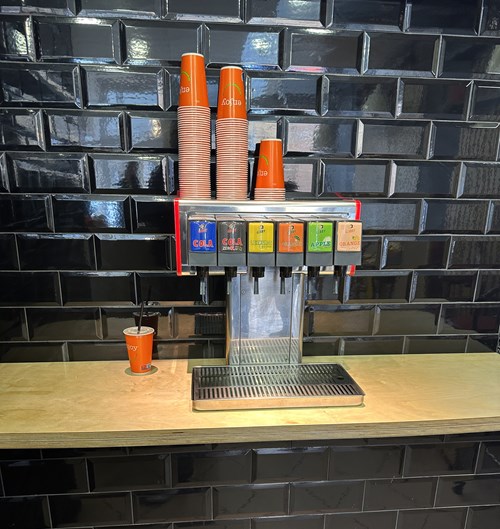 Gibby six-valve dispenser pouring in a customer venue